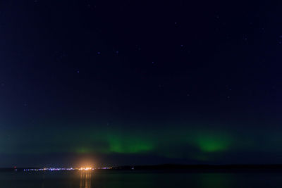 Scenic view of lake against sky at night