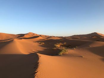 Panoramic view of desert against clear sky