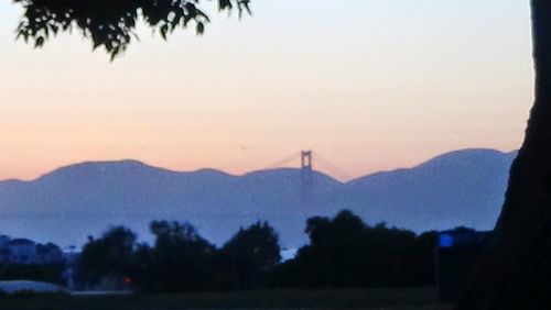 Scenic view of mountains against sky at sunset