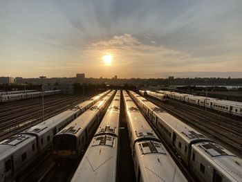 Railroad tracks against sky during sunset