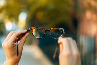 Close-up of hand holding eyeglasses