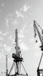 Low angle view of crane against sky