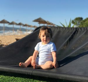 Portrait of toddler boy sitting at the beach