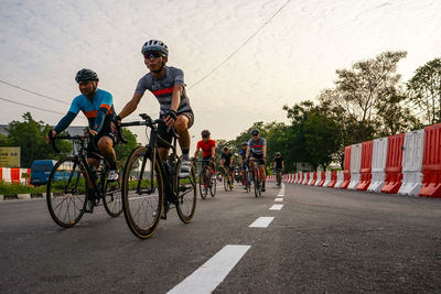 People riding motorcycle on road