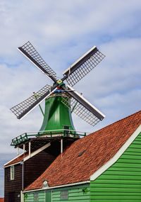 Low angle view of traditional windmill against sky