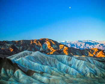 Scenic view of mountains against clear blue sky