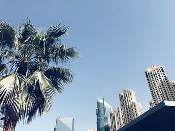 Low angle view of modern buildings against clear blue sky