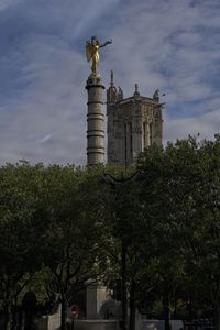 Low angle view of statue against cloudy sky