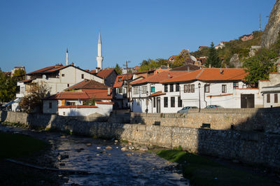 Houses in town against clear sky