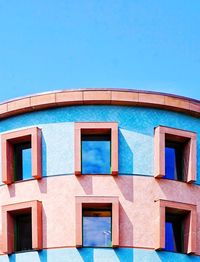 Low angle view of building against clear blue sky