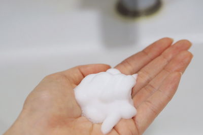 Close-up of hand holding white background