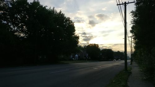 Empty road against cloudy sky