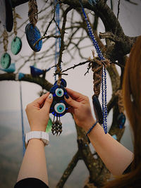 Cropped hand of woman holding chain