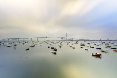 Sailboats in sea against sky