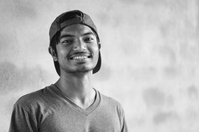 Portrait of smiling young man against blurred background