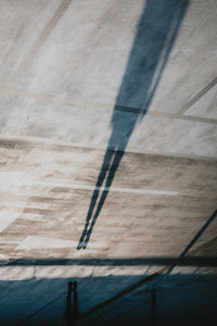 Shadow of person on road