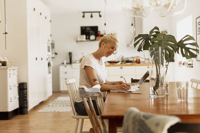 Woman using laptop at home