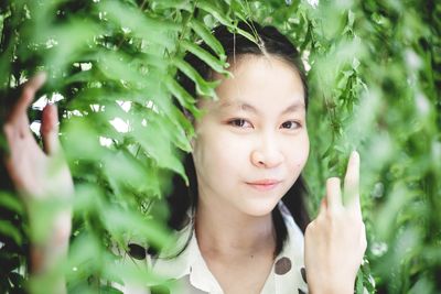 Portrait of woman against plants