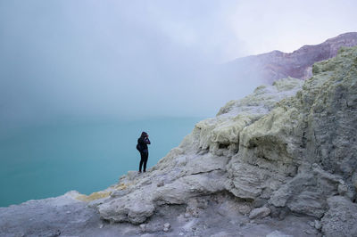 Rear view of man walking on mountain