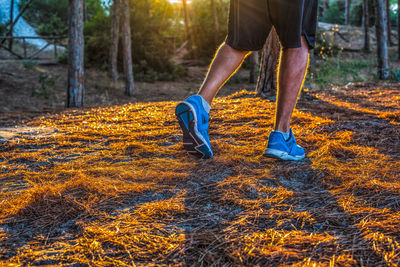 Low section of man running on land