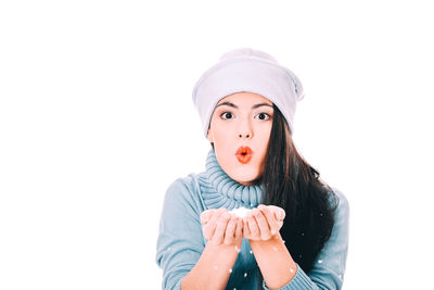 Portrait of woman wearing hat against white background