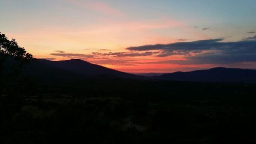 Scenic view of mountains against sky at sunset