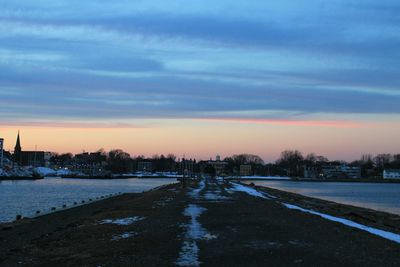 Scenic view of snow against sky during sunset