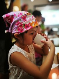 Girl drinking water indoors