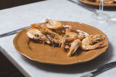 Shrimps in plate on table