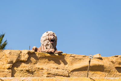 Low angle view of statue against rock formation