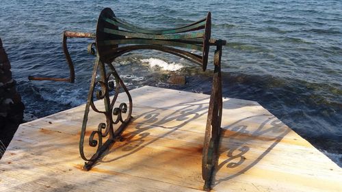 High angle view of wooden table by sea