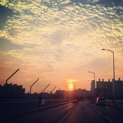 Cars on road at sunset