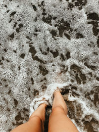 Low section of person on sand