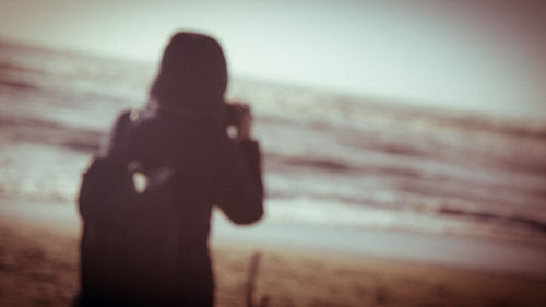 Shadow of woman on beach