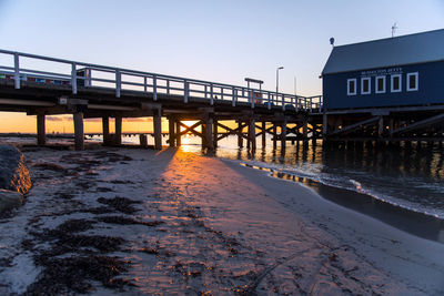 Bridge over sea against clear sky during winter