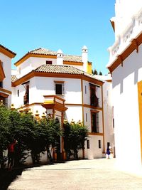 Buildings against clear blue sky