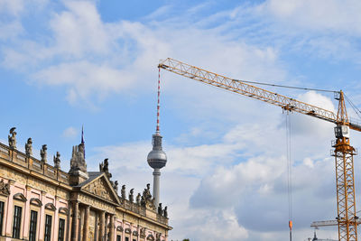 Low angle view of buildings against cloudy sky