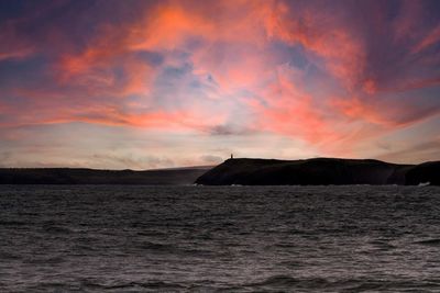 Scenic view of sea against orange sky