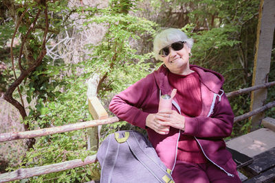 Senior woman hiking in forest trail