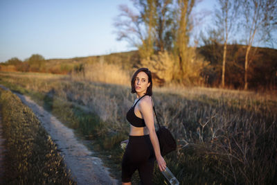 Portrait of beautiful young woman on land