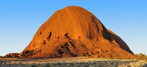 Scenic view of rock formations against clear blue sky