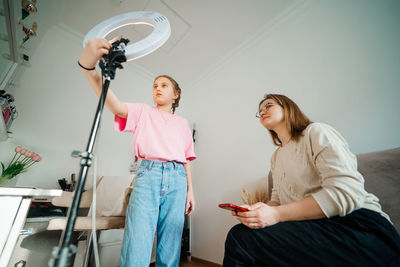 Mother and daughter record video use smartphone