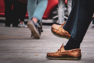 Low section of people standing on street