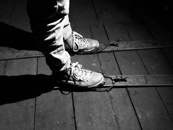 Low section of man with umbrella on footpath