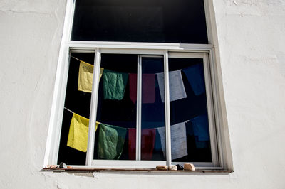 Low angle view of clothes drying against building