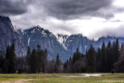 Scenic view of mountains against cloudy sky