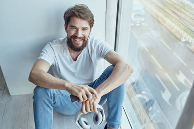 Portrait of young man exercising in gym