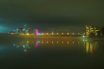 Reflection of illuminated buildings in water at night