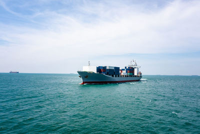 Angle view in front container ship full speed in green sea, business and industry transportation