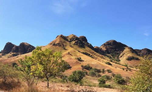 Scenic view of mountains against clear blue sky